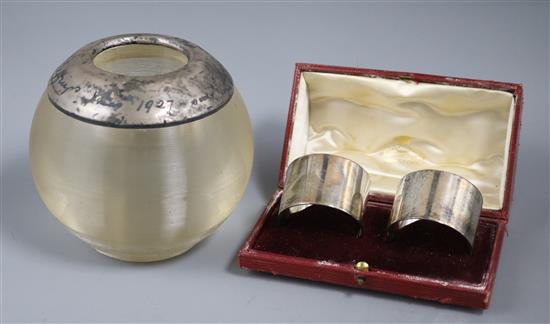 A large George V silver mounted match strike and a pair of Edwardian silver serviette rings (3)